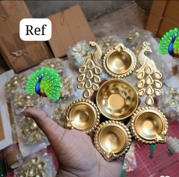 IMG-20250930-WA0051.jpg Peacock 4-Diya Urli – Decorative Metal Urli Bowl with Diyas | Festive & Home Décor